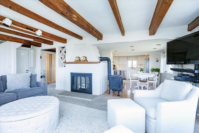 113 N Ridge Rd, Ipswich, MA 01938 - living area featuring a wood stove, light colored carpet, and beam ceiling