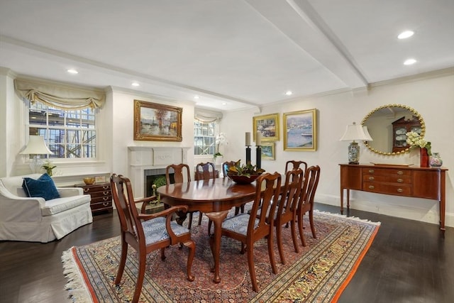 dining area with wood finished floors, crown molding, recessed lighting, and a fireplace