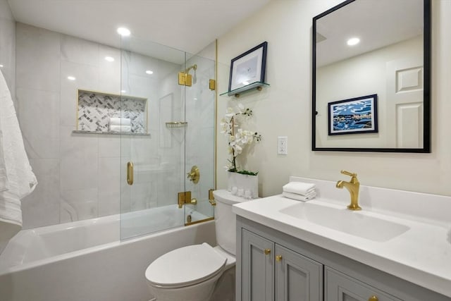 full bathroom featuring recessed lighting, vanity, toilet, and bath / shower combo with glass door