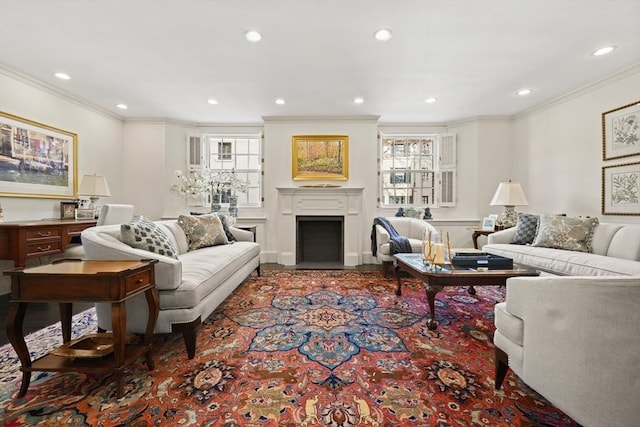 living room with a fireplace with flush hearth, a healthy amount of sunlight, and ornamental molding