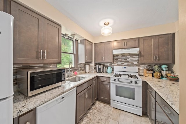 547 Washington St Unit B13, Pembroke, MA 02359 - kitchen featuring white appliances, under cabinet range hood, backsplash, and light stone counters