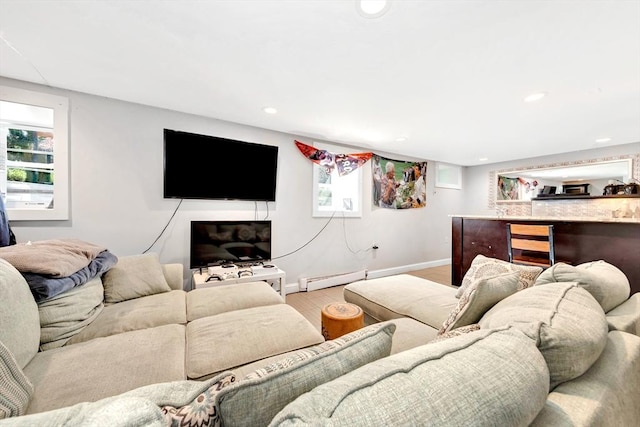 living room featuring light wood-type flooring and baseboard heating