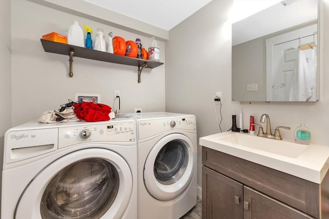 laundry area with cabinets, sink, and washing machine and dryer