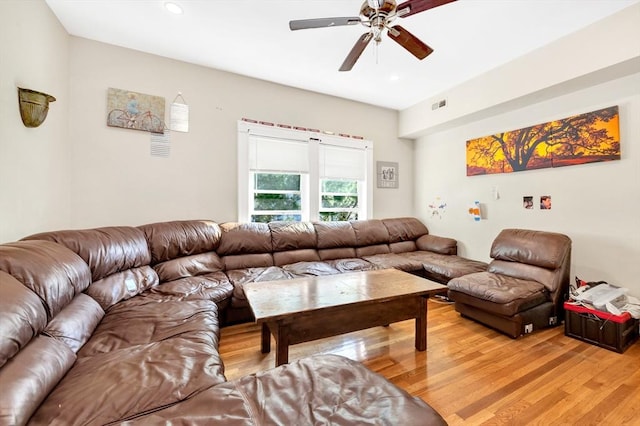 living room with hardwood / wood-style flooring and ceiling fan