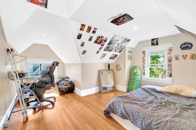 bedroom with hardwood / wood-style flooring and vaulted ceiling