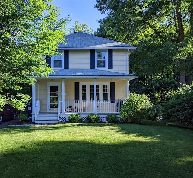 view of front of house with covered porch and a front yard