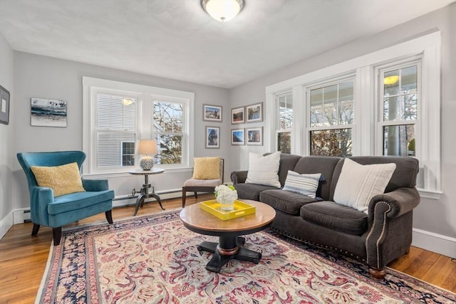 living room featuring baseboard heating and wood-type flooring