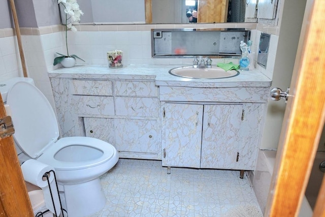 82 Jefferson Ave, Everett, MA 02149 - bathroom with toilet, tile patterned floors, tile walls, and vanity