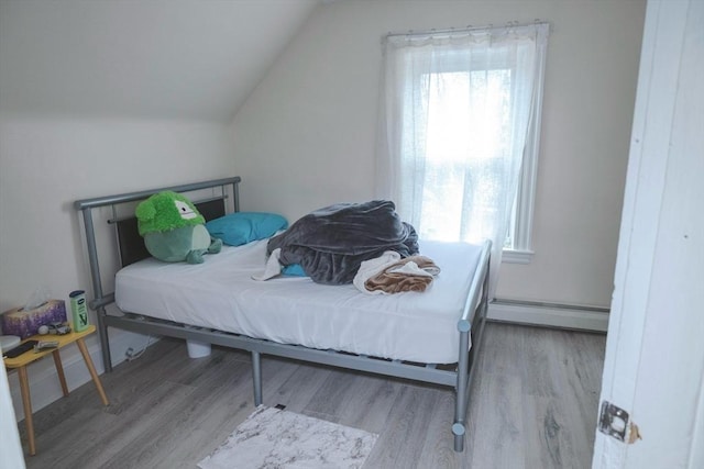 82 Jefferson Ave, Everett, MA 02149 - bedroom with wood finished floors, lofted ceiling, and a baseboard radiator