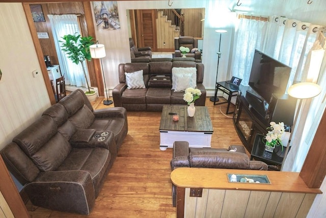 82 Jefferson Ave, Everett, MA 02149 - living room featuring stairs, baseboard heating, and wood finished floors