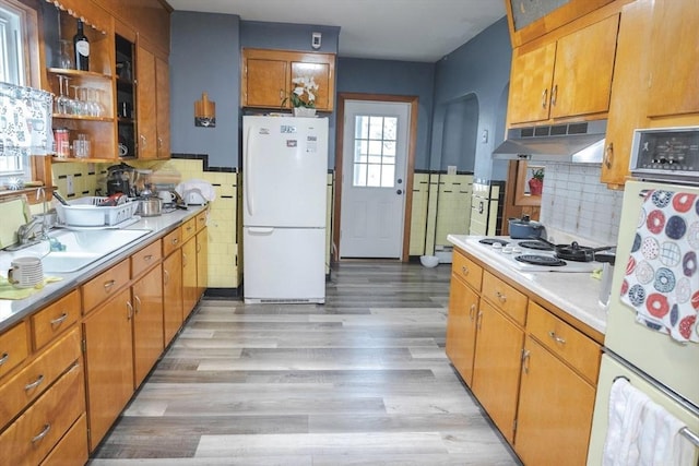 82 Jefferson Ave, Everett, MA 02149 - kitchen with white appliances, light wood-type flooring, light countertops, under cabinet range hood, and backsplash