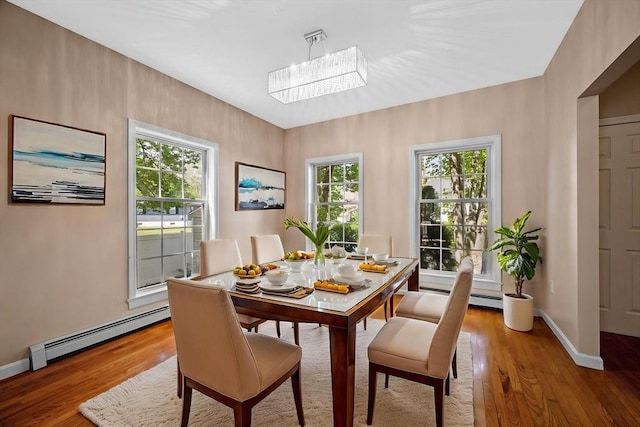 26 Harvest Rd, Reading, MA 01867 - dining space featuring a baseboard radiator and light wood-style floors