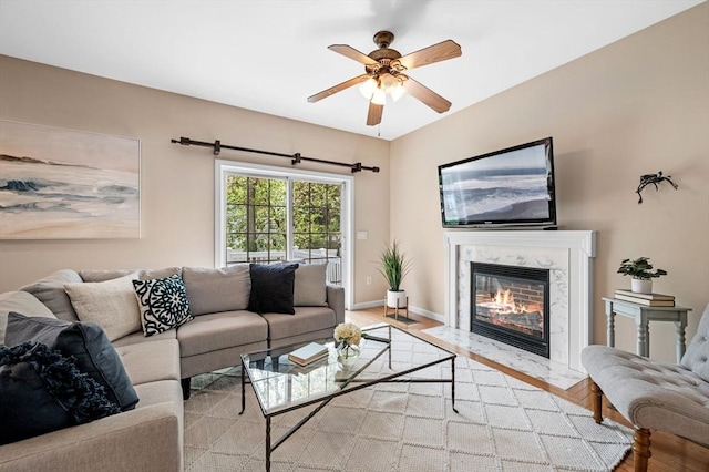 26 Harvest Rd, Reading, MA 01867 - living room with ceiling fan, a high end fireplace, and light wood-style floors