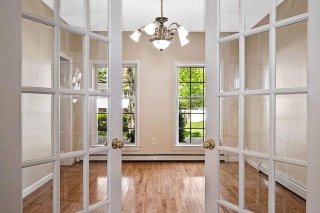 26 Harvest Rd, Reading, MA 01867 - unfurnished sunroom with baseboard heating and a chandelier