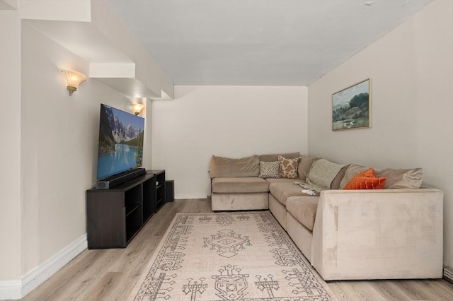 living room featuring light wood finished floors and baseboards