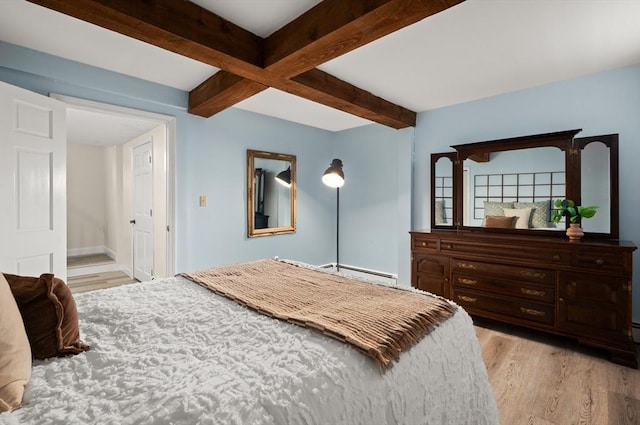 bedroom featuring light wood finished floors, a baseboard heating unit, beam ceiling, and baseboards