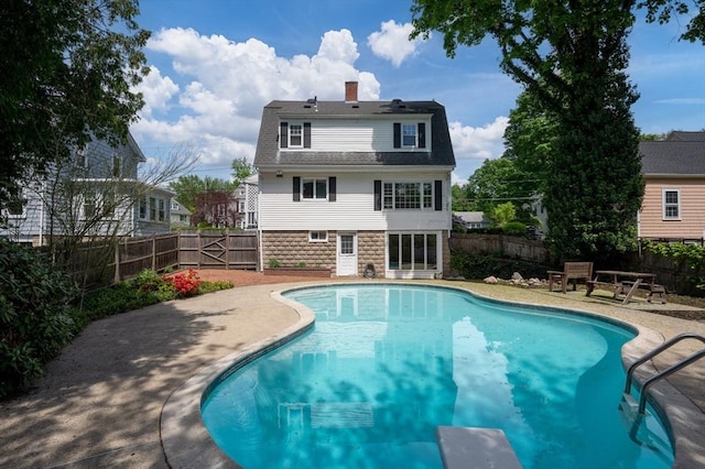 view of swimming pool with a fenced backyard and a patio area