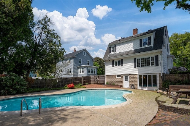 view of swimming pool with a fenced backyard and a patio