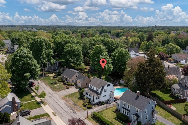 aerial view of residential area featuring a forest