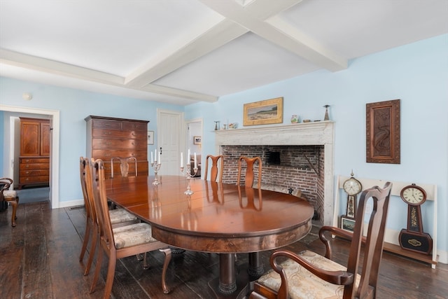 dining space featuring beamed ceiling, dark hardwood / wood-style floors, and a fireplace