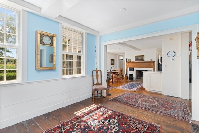 interior space with beam ceiling and hardwood / wood-style floors