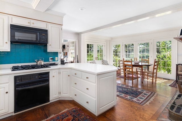 kitchen featuring kitchen peninsula, ornamental molding, dark hardwood / wood-style flooring, and black appliances