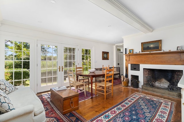 living room with ornamental molding, beamed ceiling, wood-type flooring, and french doors