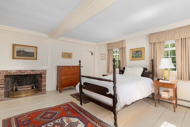 bedroom with beamed ceiling, light hardwood / wood-style flooring, a brick fireplace, and ornamental molding