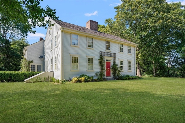 colonial home with a front lawn