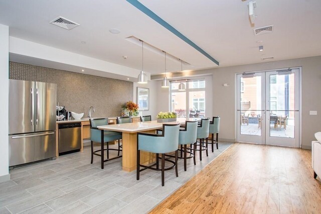 kitchen featuring stainless steel appliances, visible vents, and french doors