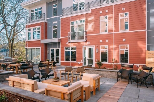 rear view of property featuring a patio and an outdoor hangout area