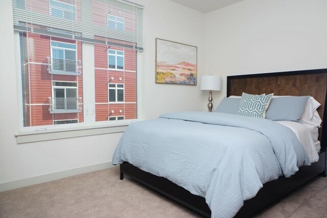 bedroom featuring baseboards and carpet flooring