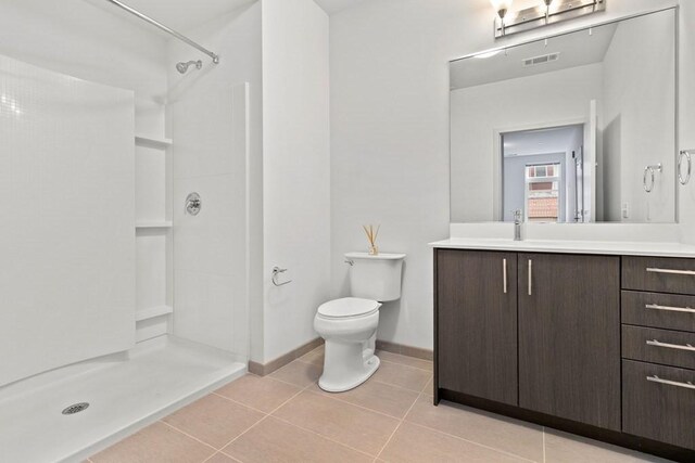 full bath featuring vanity, toilet, tile patterned floors, visible vents, and a stall shower