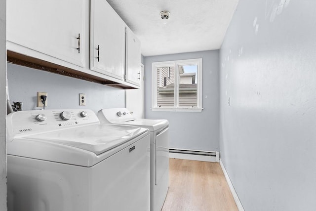 59 Harvard St, Everett, MA 02149 - washroom featuring a baseboard radiator, washer and dryer, light wood-type flooring, cabinet space, and baseboards