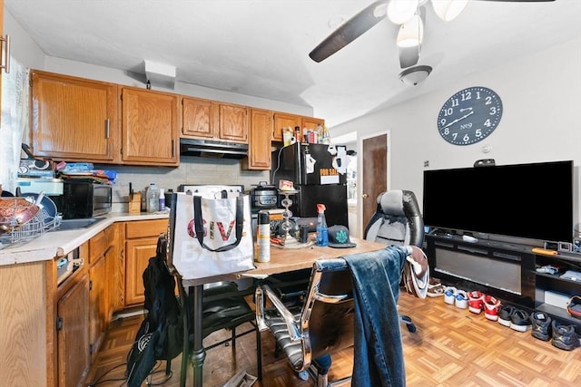 59 Harvard St, Everett, MA 02149 - kitchen featuring light countertops, under cabinet range hood, black appliances, a ceiling fan, and backsplash