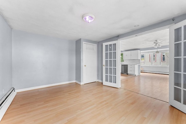 59 Harvard St, Everett, MA 02149 - unfurnished room with a baseboard heating unit, light wood finished floors, french doors, and baseboards