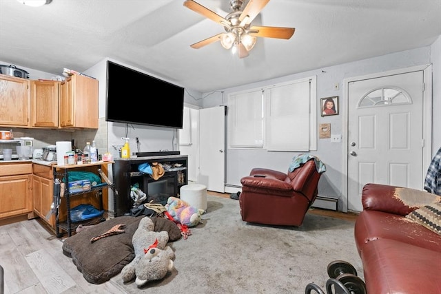 59 Harvard St, Everett, MA 02149 - living room with light wood-style floors, ceiling fan, and a baseboard radiator