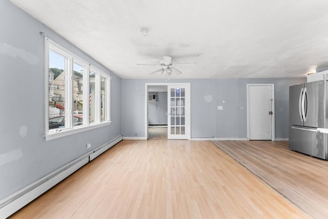 59 Harvard St, Everett, MA 02149 - unfurnished living room featuring baseboard heating, a ceiling fan, light wood-style flooring, and baseboards