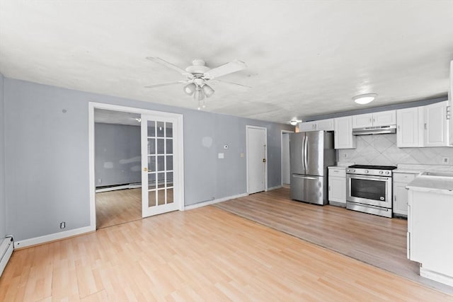 59 Harvard St, Everett, MA 02149 - kitchen with appliances with stainless steel finishes, under cabinet range hood, light countertops, light wood-style flooring, and baseboards