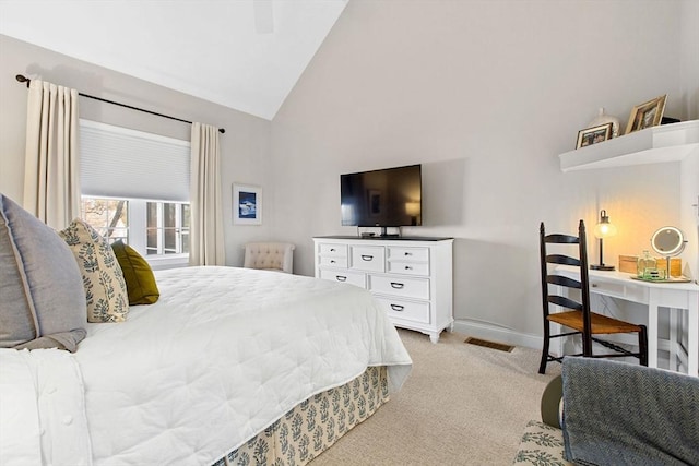 bedroom featuring a ceiling fan, visible vents, baseboards, high vaulted ceiling, and light colored carpet