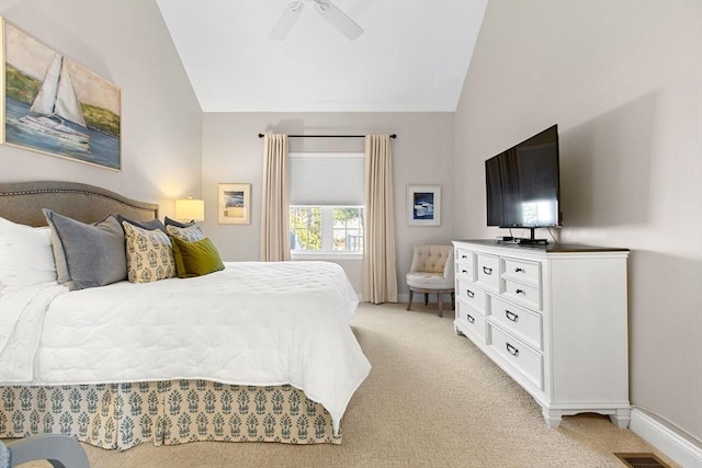 bedroom with vaulted ceiling, baseboards, and light carpet