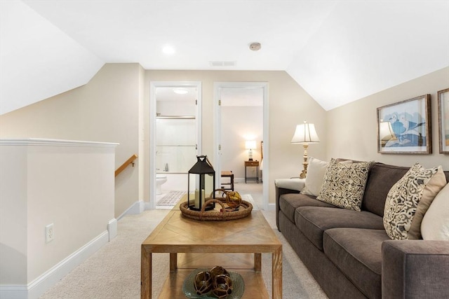 living room featuring visible vents, baseboards, lofted ceiling, and carpet floors