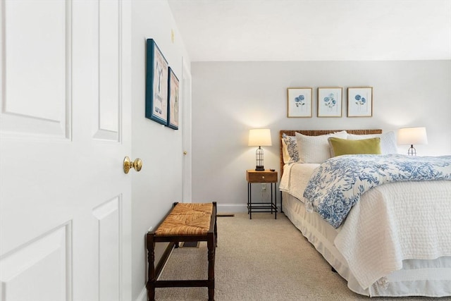 bedroom featuring light carpet and baseboards