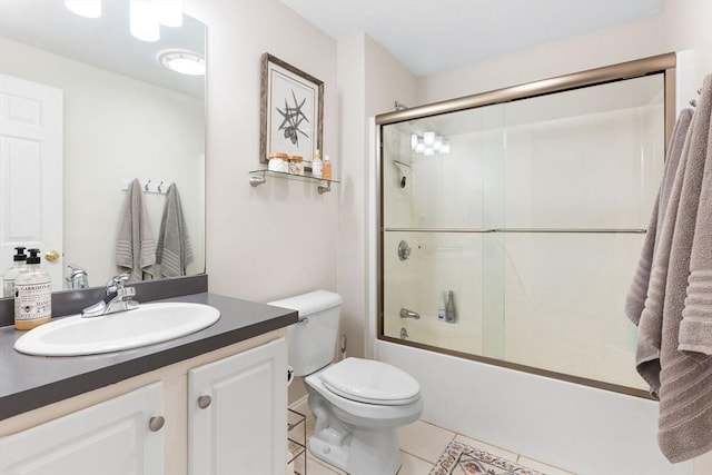 full bathroom with tile patterned flooring, toilet, vanity, and shower / bath combination with glass door