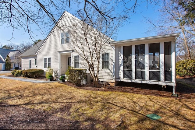 view of front of home featuring a front lawn and a sunroom