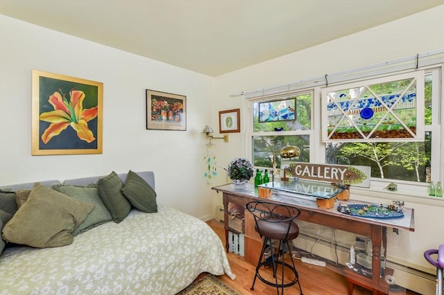 bedroom with wood finished floors and baseboards