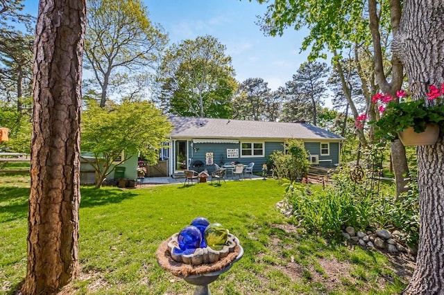 back of property featuring a patio and a lawn