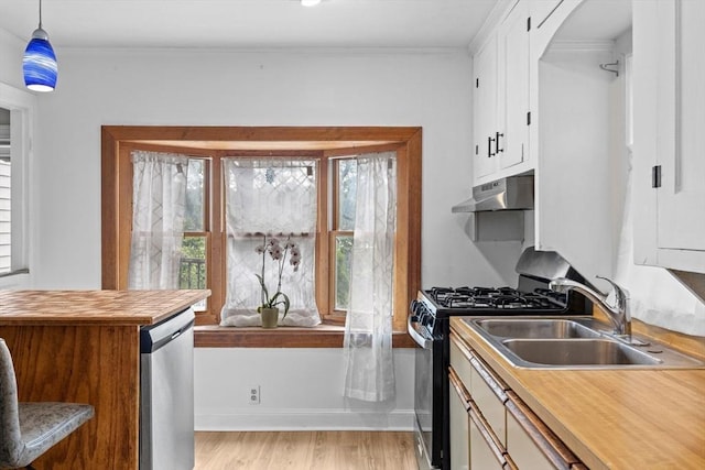 94 Clinton Rd, Weymouth, MA 02189 - kitchen featuring appliances with stainless steel finishes, under cabinet range hood, arched walkways, butcher block counters, and white cabinetry
