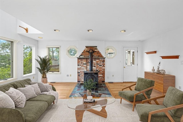 94 Clinton Rd, Weymouth, MA 02189 - living area with plenty of natural light, light wood-style flooring, recessed lighting, and a wood stove