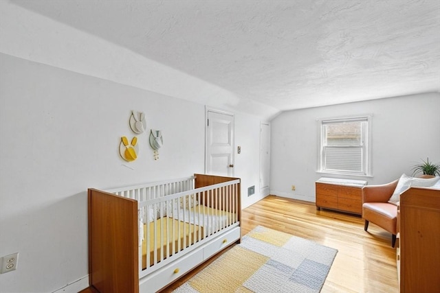 94 Clinton Rd, Weymouth, MA 02189 - bedroom featuring wood finished floors, lofted ceiling, and a textured ceiling